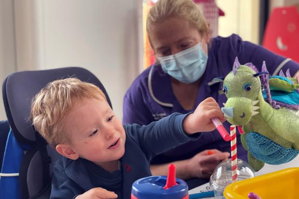 Rebecca House nurse and child playing