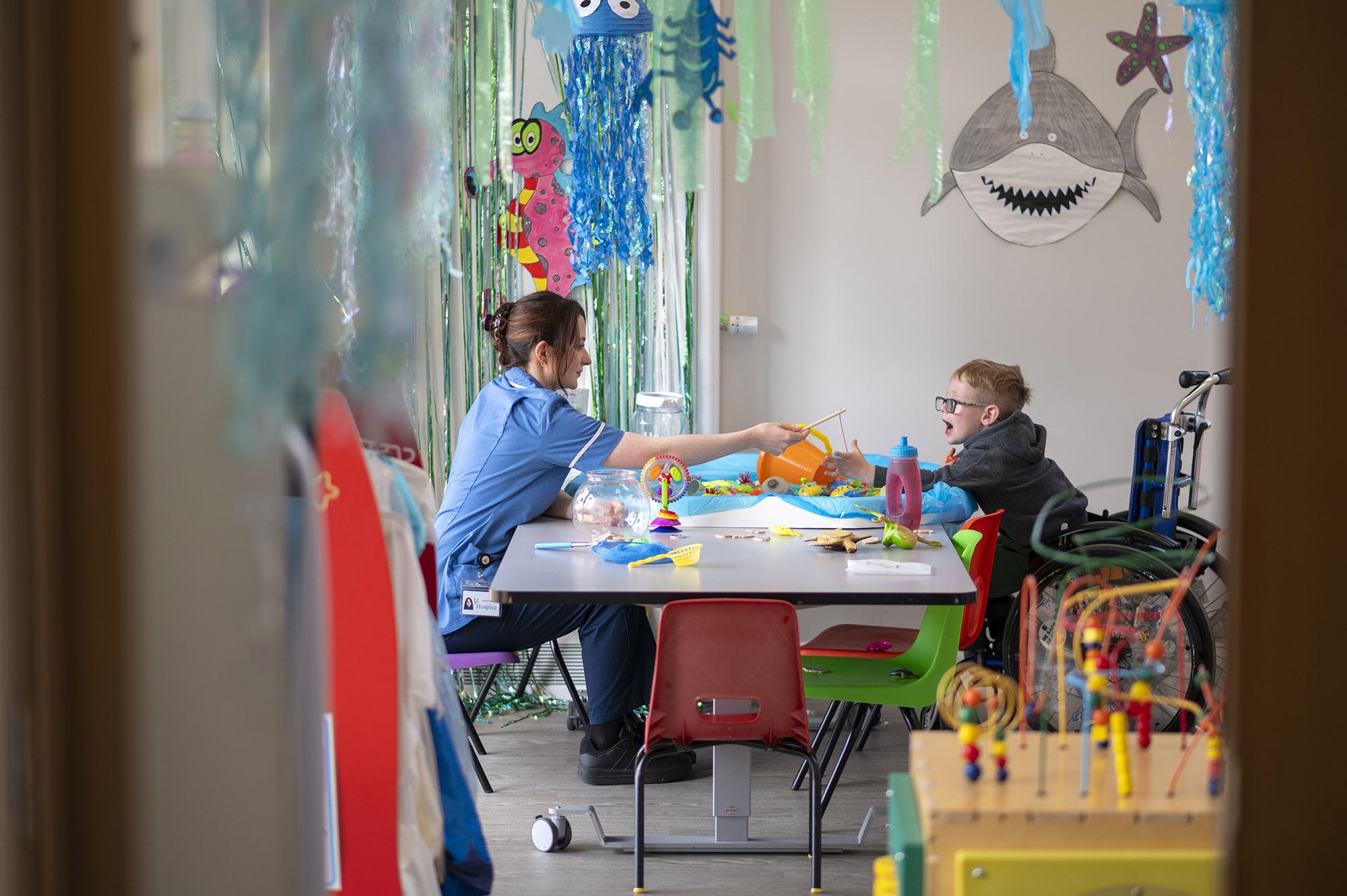 Rebecca House nurse plays games with child