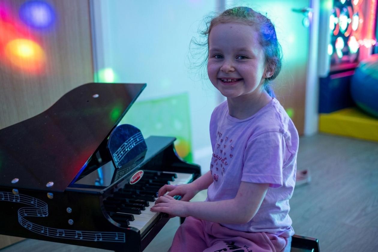 Rebecca House child with toy piano